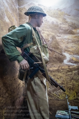A soldier of the 2/16th Australian Infantry Battalion late 1942/early 1943. He is armed with a Thompson submachine gun and is dressed in the transitional uniform of khaki trousers and dyed shirt. By September 1943 when the battalion commenced operations in the Markham Valley, the Thompson had been replaced by the Owen submachine gun and jungle green trousers. Photo: Julian Tennant