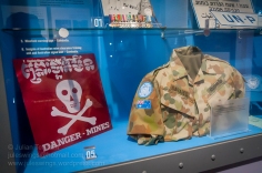 Mine warning sign and shirt worn by Corporal Steve Danaher (RASIGS) whilst deployed to Cambodia as part of the UNTAC mission in 1993. Photo: Julian Tennant