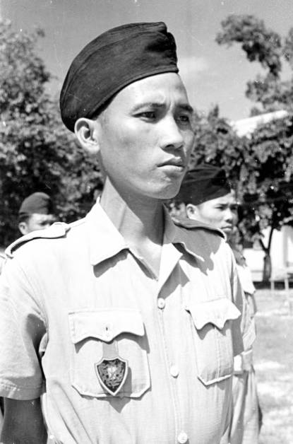 1950 portrait of a Cao Đài soldier wearing the distinctive pocket crest badge. This is the locally made variation. Photo: Harrison Forman LIFE Magazine 1950.