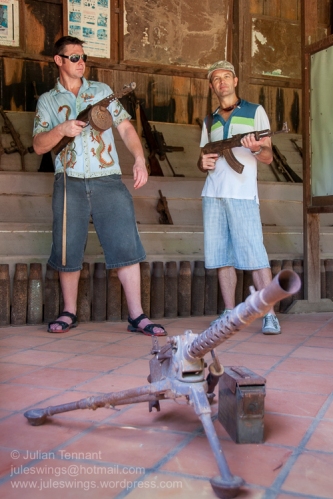 Tourists playing with some of the rusted weapons on display the War Museum Cambodia. Photo: Julian Tennant