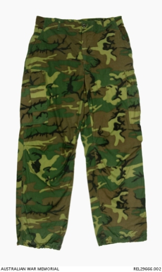 ERDL camouflage trousers : Trooper D R Barnby, 2 Squadron, Special Air Service Regiment. Description: Pair of ERDL camouflaged Ripstop trousers, fitted with olive green plastic buttons. A pair of slash pockets are fitted at the hips. The trousers have a waist band with four belt loops and a concealed button fly closure. The trousers feature a concealed map pocket, with button opening on each thigh. The bottom of each trouser leg has an internal loop of fabric to blouse the trousers. The Ripstop material in the trousers includes nylon threads cross hatched through the cotton base fabric. History / Summary This distinctive camouflage is the ERDL pattern which was developed by the United States Army at the Engineer Research & Development Laboratories (ERDL) in 1948, and was first issued to US special operations units and the Australian Special Air Service Regiment (SASR) operating in South Vietnam from early 1967. This ERDL variation is also known as the brown based 'highland' or 'wet season' type. AWM Accession Number: REL29666.002