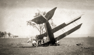 NSW State Aviation School Curtiss Jenny JN4 training aircraft after a crash whilst being flown by K.A. Hendy. November 1918. Source: Collection of photographs of WWI NSW State Aviation School, Museum of Applied Arts & Sciences.