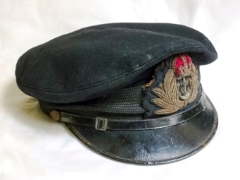 Royal Navy officers cap belonging to Sub Lieutenant John Ellis who was the second in command of Landing Craft Tank 2130. LCT 2130 was an LCT Mk.V and was part of 104th LCT Flotilla. On D-Day LCT 2130 took American troops from Dartmouth in the UK and landed them on Utah Beach around 11.20am. For the next three months it continued to carry troops over to Normandy. Ellis wore this cap on the many journeys his ship made to Normandy.