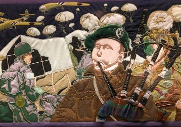 Detail of the Overlord Embroidery showing Lord Lovat's piper Bill Millin of the 1st Special Service Brigade in the foreground with American paratroopers behind.