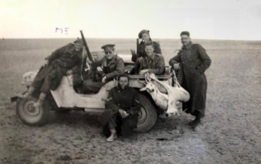 Members of Fred Casey's patrol from 1 SAS posing for a photo after hunting impala in North Africa, 1942. Fred Casey is on the front bonnet.